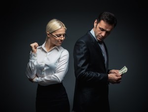 Businessman and businesswoman with money